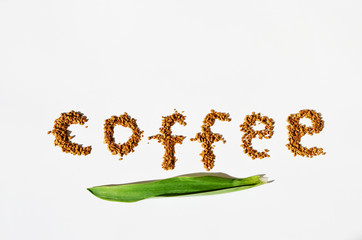 Granulated instant coffee in a shape of text  on a white background,photo