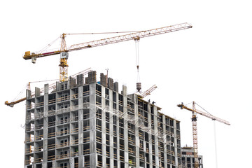 High-rise building crane with a long arrow of yellow color on a white background above a concrete building under construction with brick walls