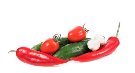 .peppers, tomatoes, cucumbers and garlic on a white background