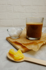 Bulletproof coffee with ghee oil and coconut oil on neutral grey background. Image with copy space.