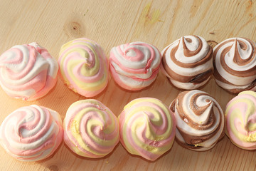 Marshmallow and whipped cream biscuits, selective focus. Tasty crumbly homemade cakes with tea on a sunny background.
