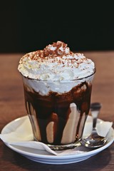 Mocha coffee drink with cream in a glass isolated