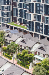 many suburban houses near modern city building, summertime