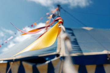 Close-up macro of colorful pennants in a blue circus tent