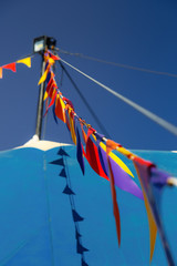 Colored pennants in a blue circus tent