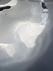 Dark ice hole with sun flares. Nature art