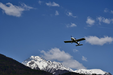 Fototapeta na wymiar Propeller plan over Valtellina mountains