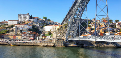 Porto cityscape with buildings and boats close to the Luis I Bridge - Portugal