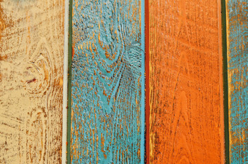 Rustic wooden background painted in orange, blue and beige.