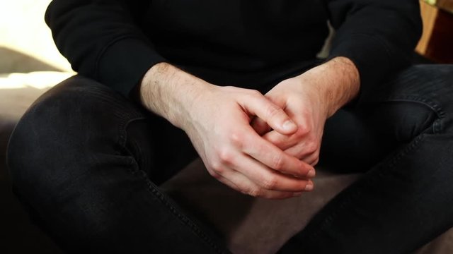 Close-up of man gesticulating with hands while discussing a family problem at the couple&rsquo;s therapy.