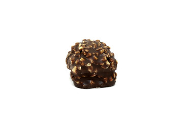 Delicious Russian brown sweet chocolate ball filled with hazelnuts close-up isolated on white background. Candy covered with many crushed nuts on top.