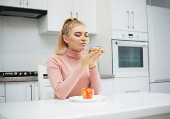 Diet. The concept of healthy and unhealthy nutrition. The model plus size makes a choice in favor...