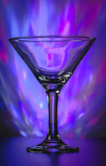 Martini Glass with flashing bright violet lights on background