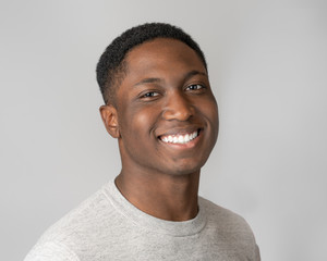 Portrait of black millennial man on gray background