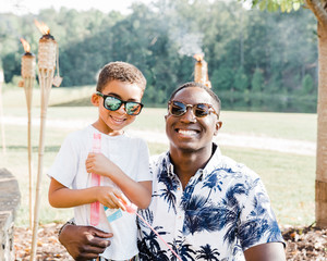 mixed race boy with man outside