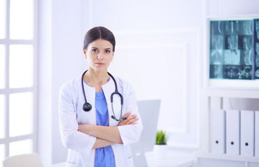 Young smiling female doctor with stethoscope at doctor's office