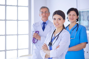 Fototapeta premium Group of doctors and nurses standing in a hospital room