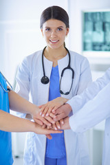 Group of doctors putting their hands together