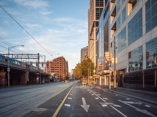 Morning view of Flinders Street in Melbourne's CBD with modern office buildings on one side and...