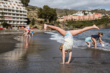 Kids playing on the beach happy doing pirouettes © lymdigital