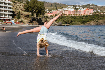 Kids playing on the beach happy doing pirouettes © lymdigital