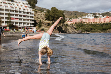 Kids playing on the beach happy doing pirouettes © lymdigital