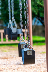 empty swings in an empty playground