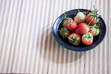Strawberry in a black plate