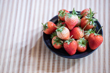 Strawberry in a black plate