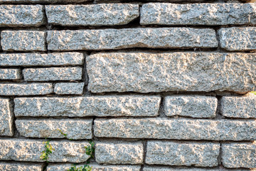 Grey pattern rock wall with sunlight for background , copy space and wallpaper