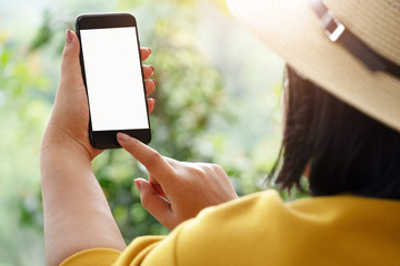 woman's hand holding and using smartphone, black screen with blur background. subject is blur.