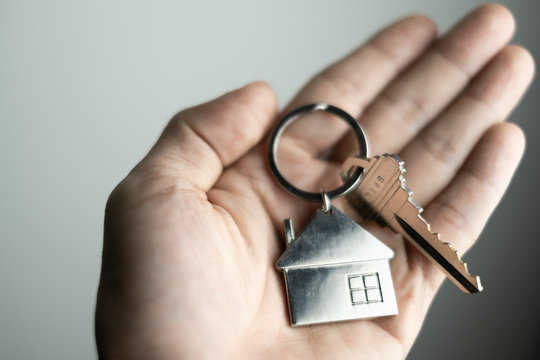 closeup key on human hand, personal loan concept. soft focus.