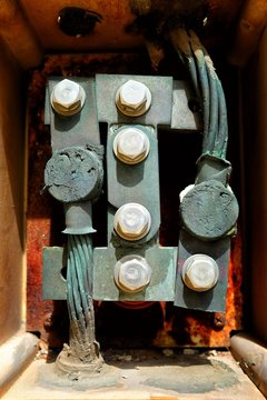 Close up, Ground Electrical Connection Box of Lightning Rod on Yellow Grunge Concrete Wall Background.