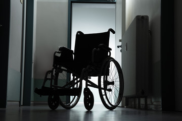 Empty Wheel Chair In Hospital Corridor