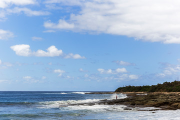 Man fishing with two rods along Great Ocean Road Victoria Australia.