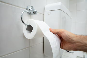Person's Hand Using Toilet Paper