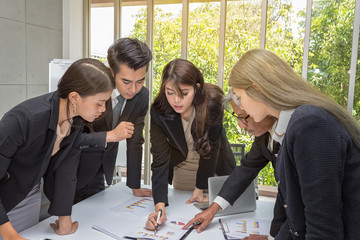 Businessmen are planning the event next year. Group business working meeting room at the office. Team workers are talking business plan and presenting to colleagues at a meeting. Asian people.