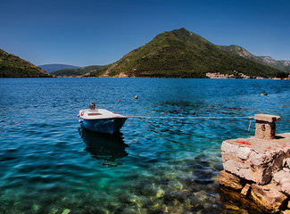 boat in the sea tied alongside near town of Kotor