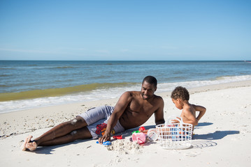 Fototapeta premium father and son playing in the sand