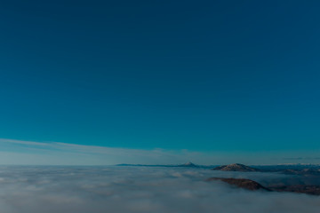 Rare early morning winter fog over the city skyline of the sea bay and skyscrapers before sunrise.