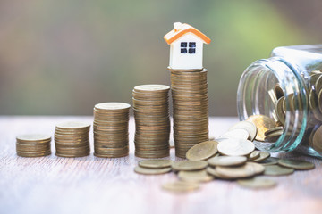 Mini house on stack of coins,Money and house, Mortgage concept, Real estate investment, Real estate...