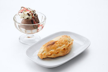 close up view of nice yummy empanada  with ice cream on white table