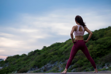 Rear view of Happy healthy women practicing yoga. standing start now against yoga relaxing easy practicing yoga. .beautiful landscape view sky on evening nature evening outdoor.