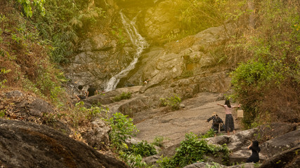 People are soaking in cold water at Huay Kaew Waterfall in Chiang Mai, Thailand.