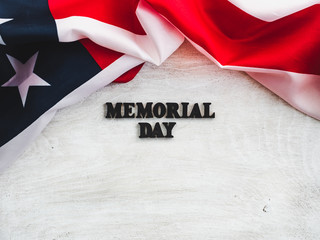 Fototapeta na wymiar Beautiful card for the Memorial Day. Wooden letters with a congratulatory inscription on a white background. Close-up, top view. Congratulations for loved ones, relatives, friends and colleagues