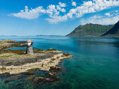 Gimsoy lighthouse on sea rocks, Lofoten Norway