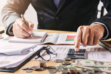 businessman working in office using calculator for calculate budget money