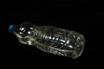 Plastic water bottle isolated on black background