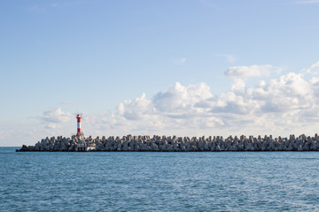 View of the city coast from the sea, lighthouse, ship