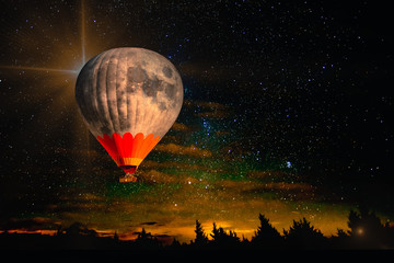 Colorful hot air balloon - moon rises very high in night starry sky above horizon. Collage. Dream come true concept. Elements of this image furnished by NASA.